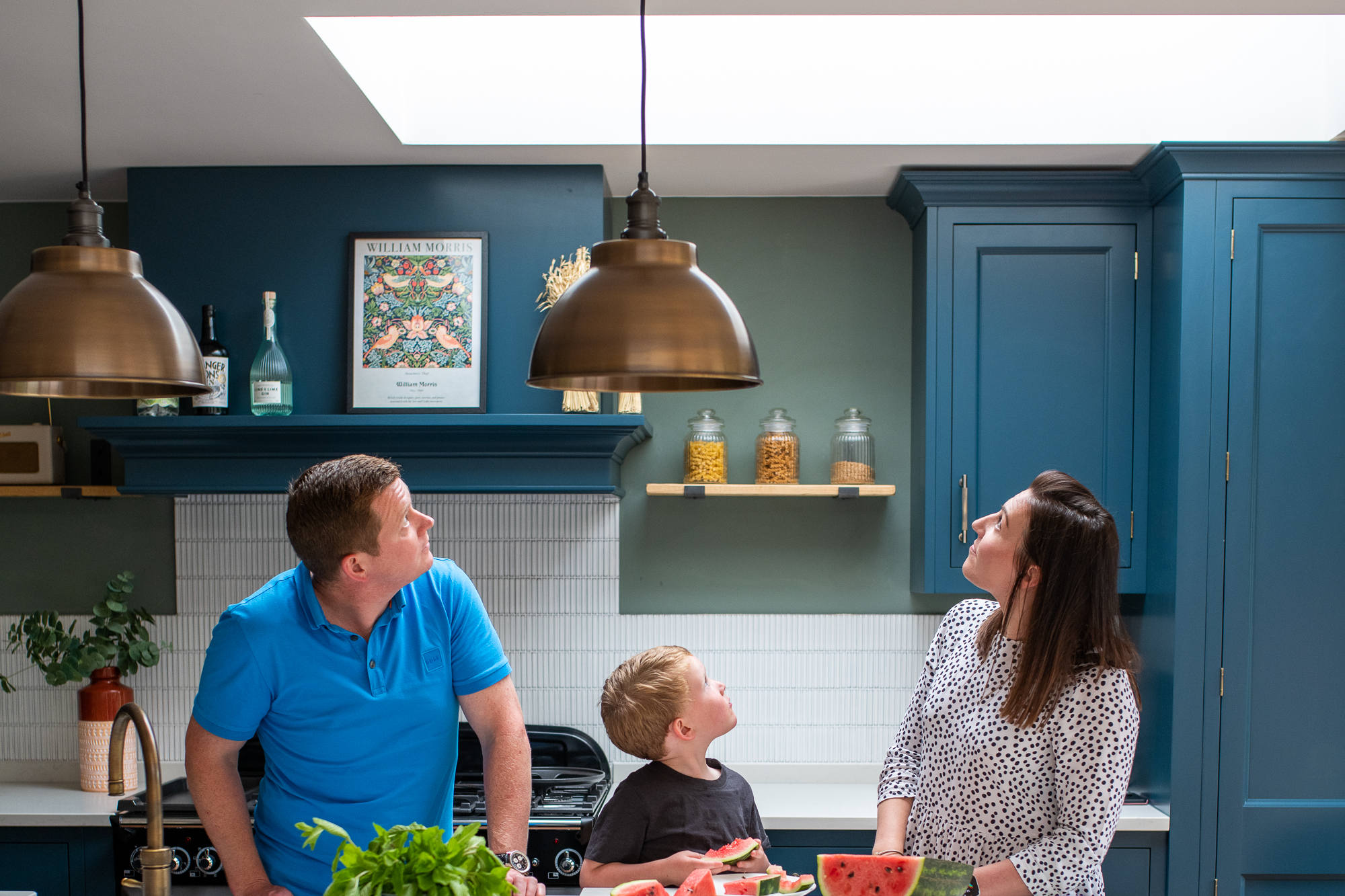 Family of three looking up to a rooflight