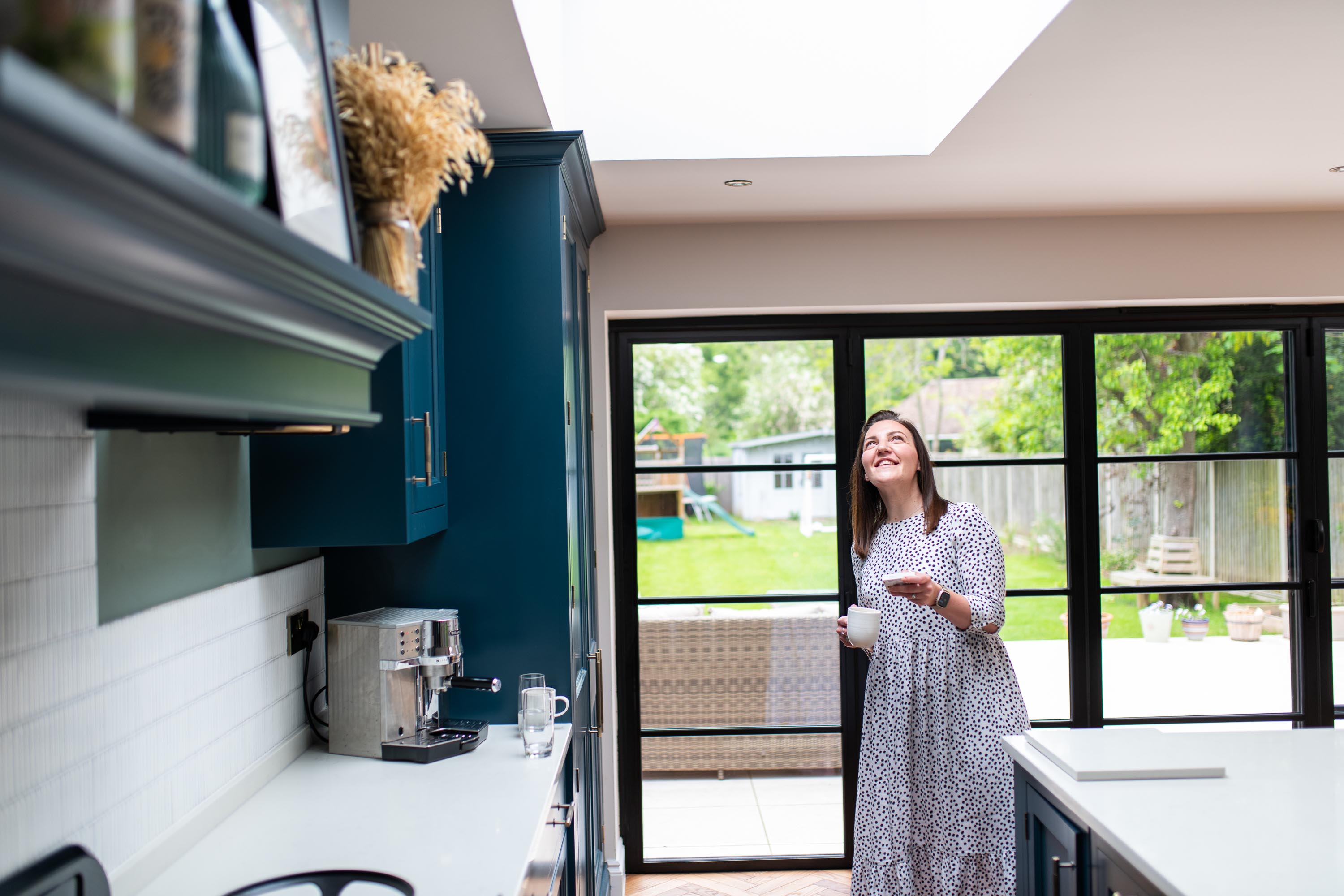 woman opening rooflight with velux active 